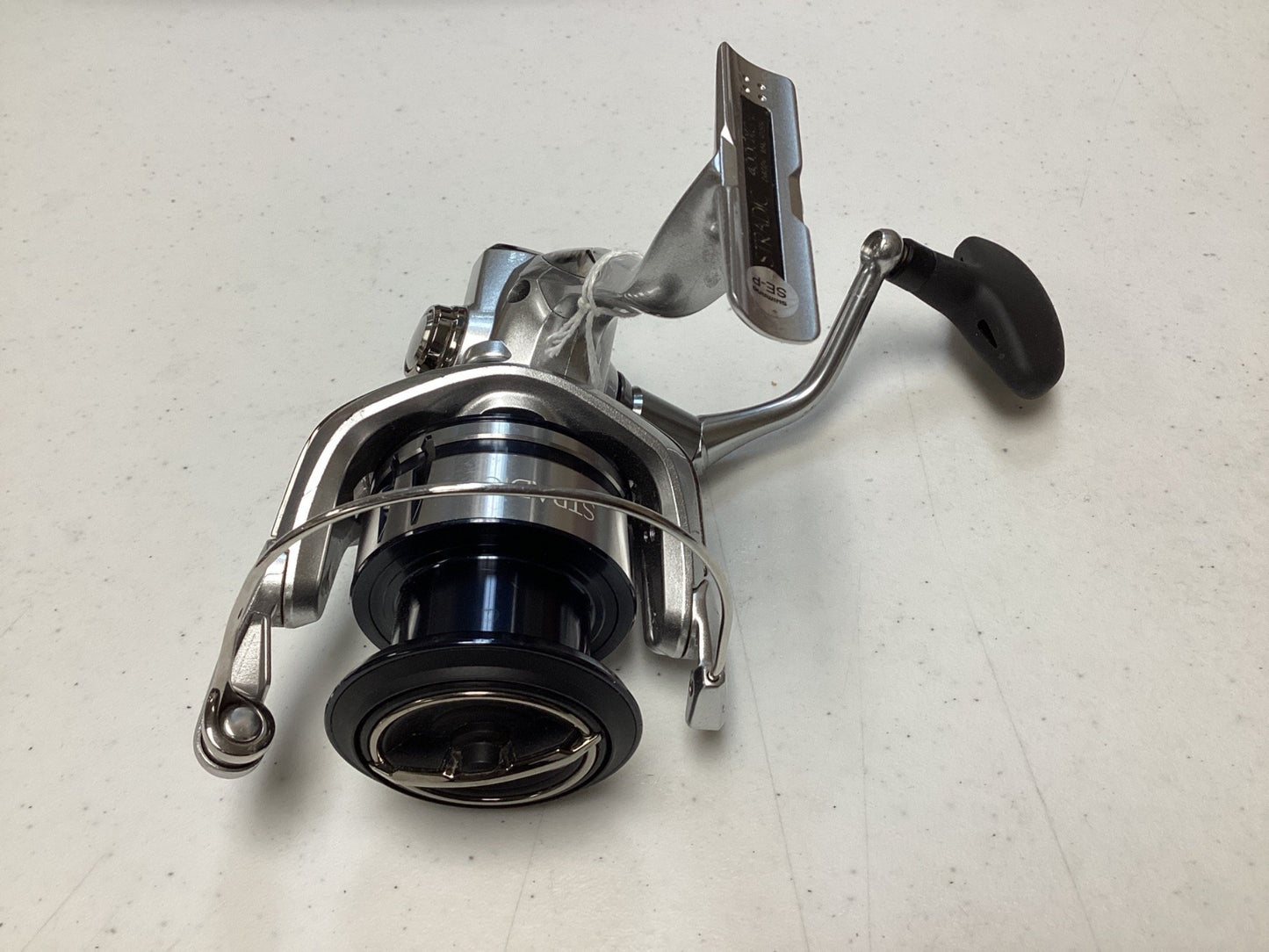 A close-up of a Shimano Stradic FL ST4000XGFL Used Spinning Reel in very good condition, featuring a metallic finish and black spool—ideal for anglers trading in gear for store credit via our Rod and Reel Trade-In Program.