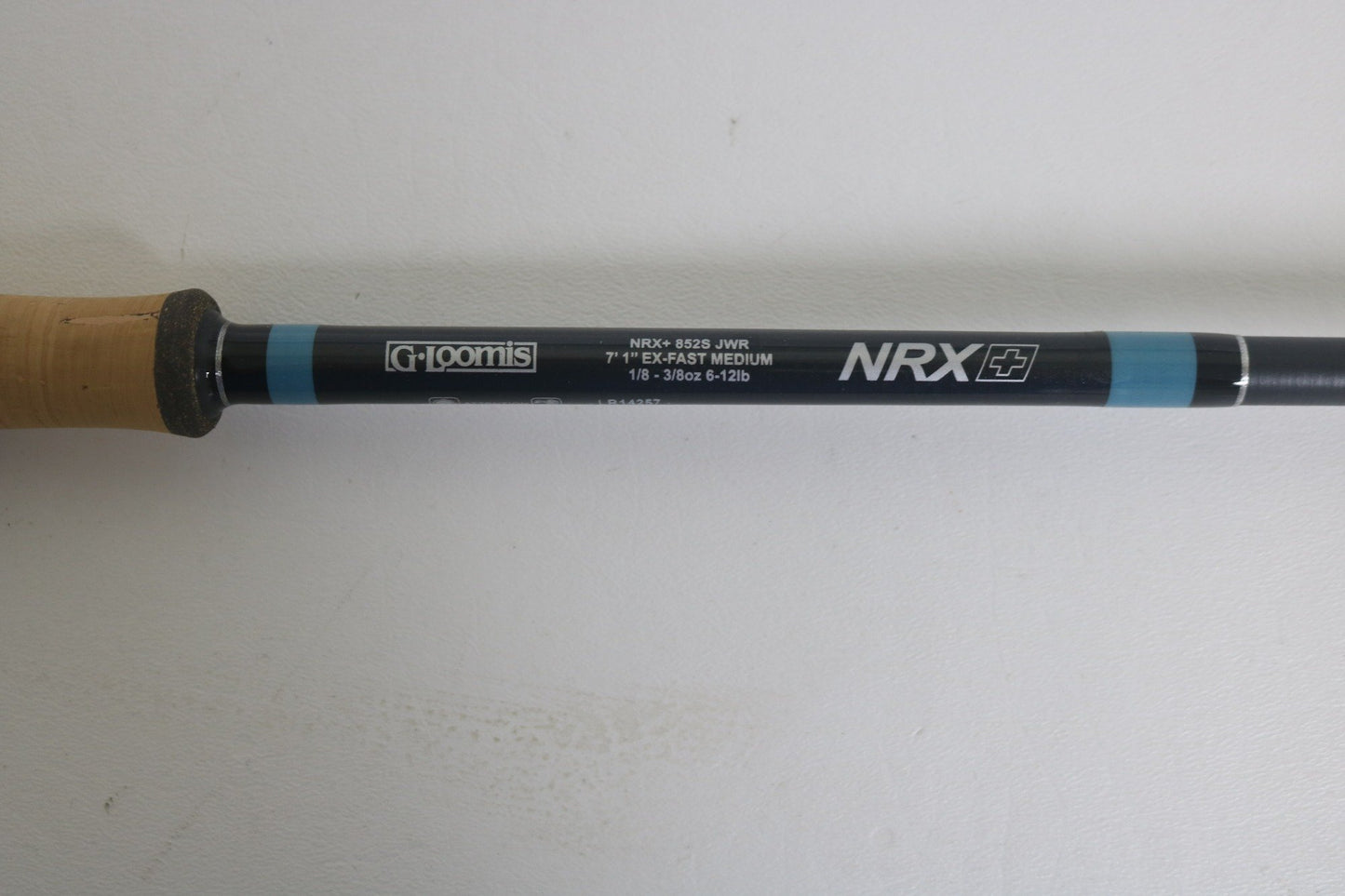 Close-up of a G. Loomis NRX+ 852S JWR Used Spinning Rod in excellent condition on a white background. Trade in your used gear for store credit during our Rod and Reel Trade-In event!.