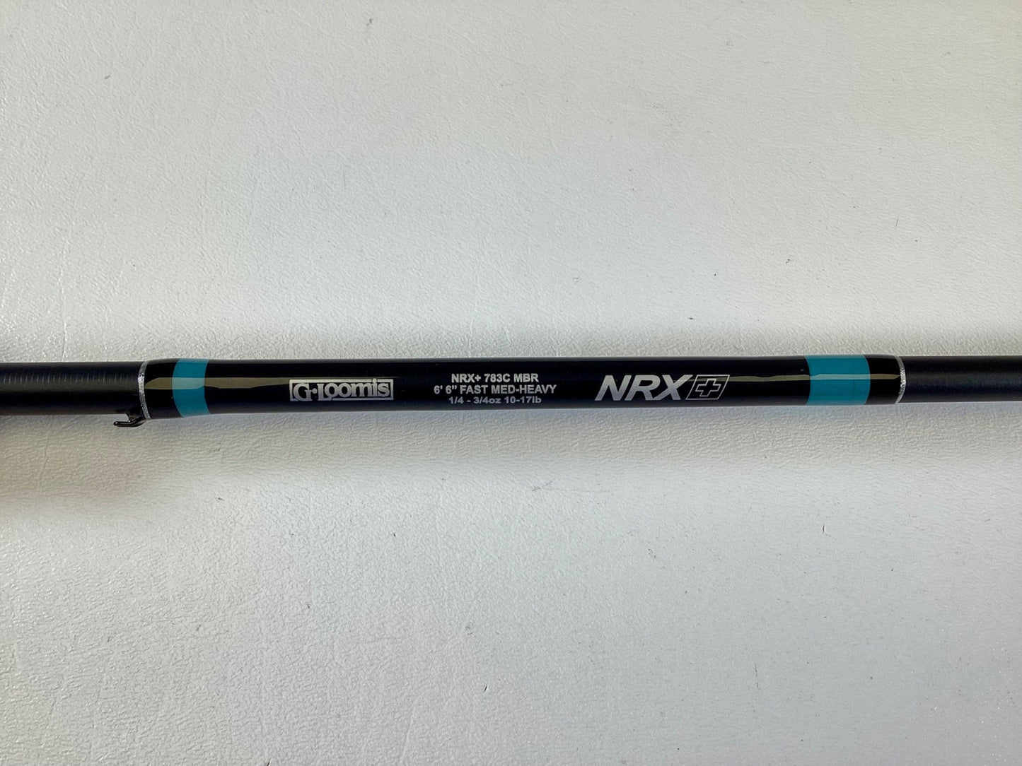 A close-up of a black G. Loomis NRX+ 783C MBR 6'6" Medium Heavy Casting Rod in excellent condition—ideal for upgrading through our Rod and Reel Trade-In Program.