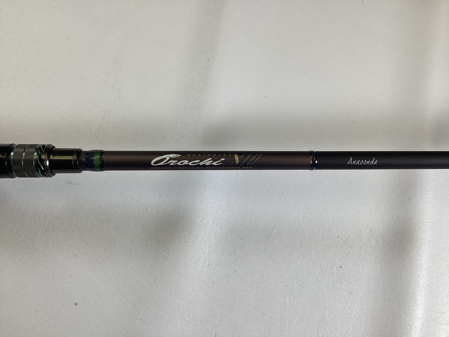 A close-up of a Megabass Orochi X10 F9-710XT Anaconda 7'10" XXH used casting rod in excellent condition—ideal for anglers or those trading in gear for store credit.