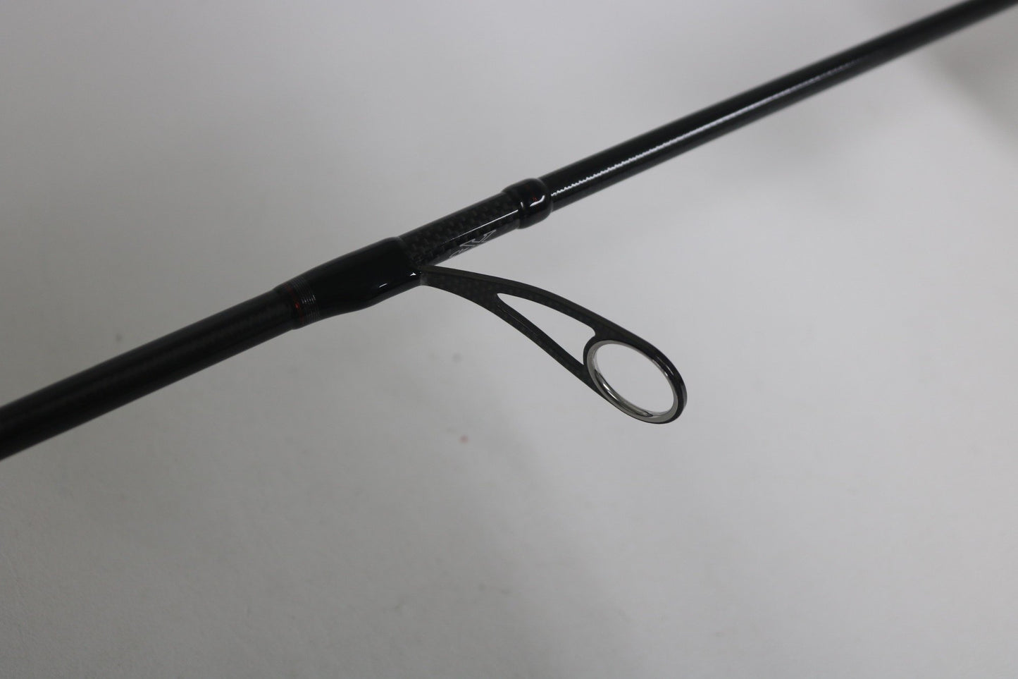 Close-up of the Daiwa Steez AGS spinning rod guide against a plain background. The sleek black design enhances the guide's simplicity. Upgrade your used gear with our Rod and Reel Trade-In Program, and potentially earn store credit for your next adventure.