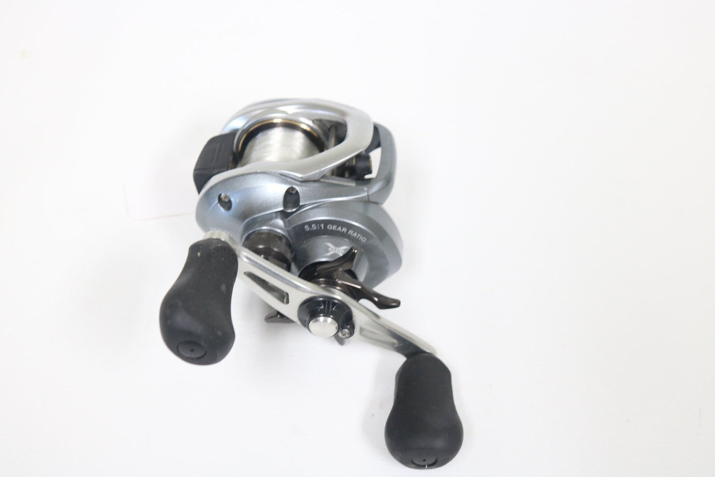 The Shimano Curado I 200PG 5.5:1 Used Casting Reel in excellent condition is shown on a white background, ideal for those interested in Used Gear or trading in rods and reels for store credit.
