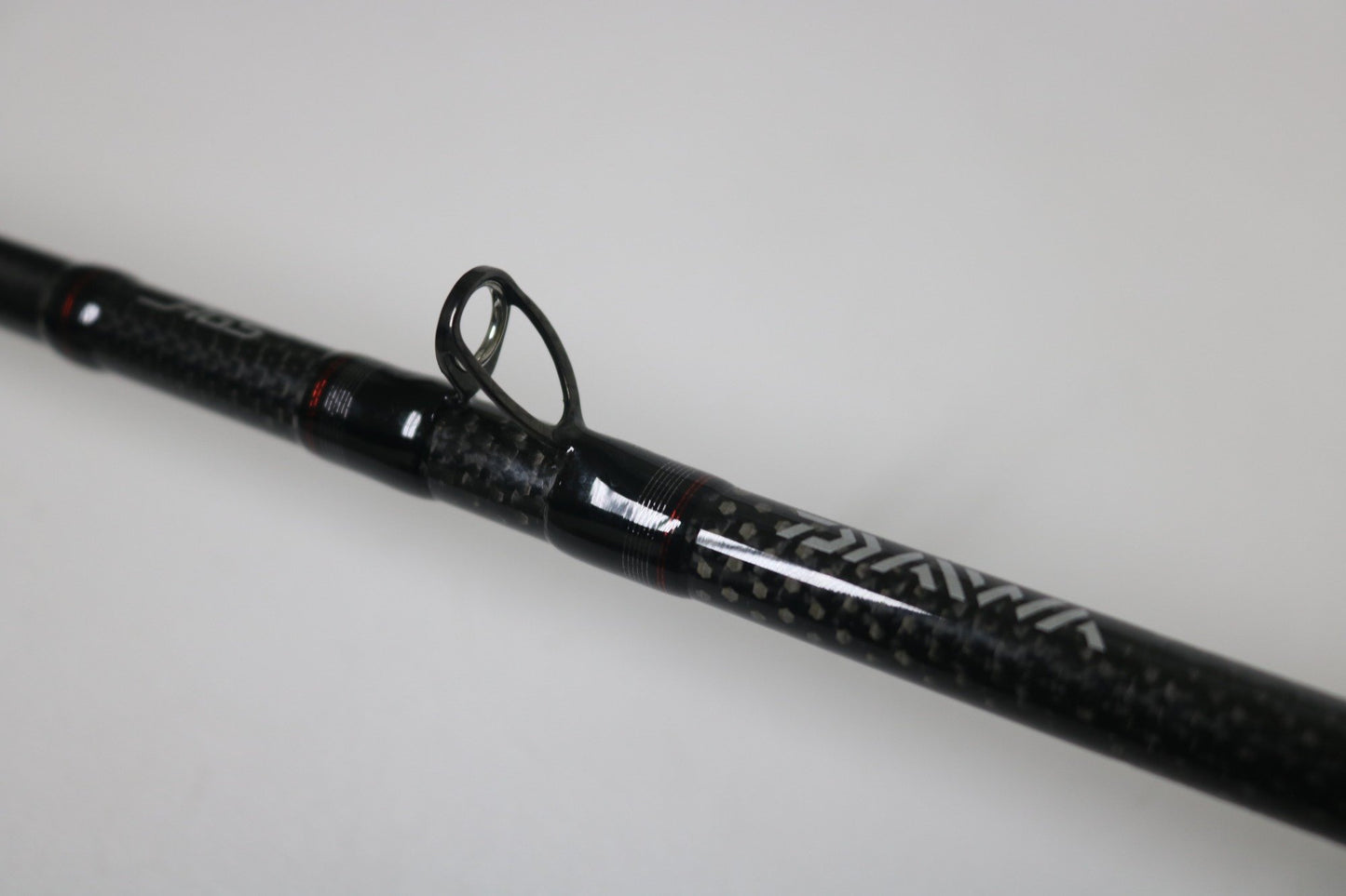 Close-up of a Daiwa Steez AGS STAGS741XHFB used casting rod in excellent condition, featuring a black finish, visible line guide, and textured grip against a plain white background.
