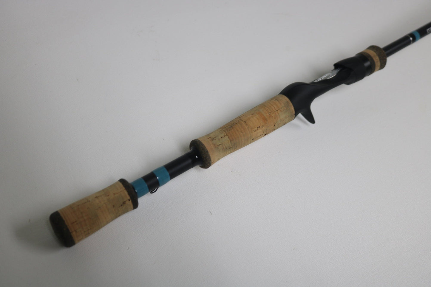 A close-up of the G. Loomis NRX+ 802C JWR Used Casting Rod—featuring cork handles and a black reel seat—offers an excellent upgrade option for those trading in gear through the Rod and Reel Trade-In Program.