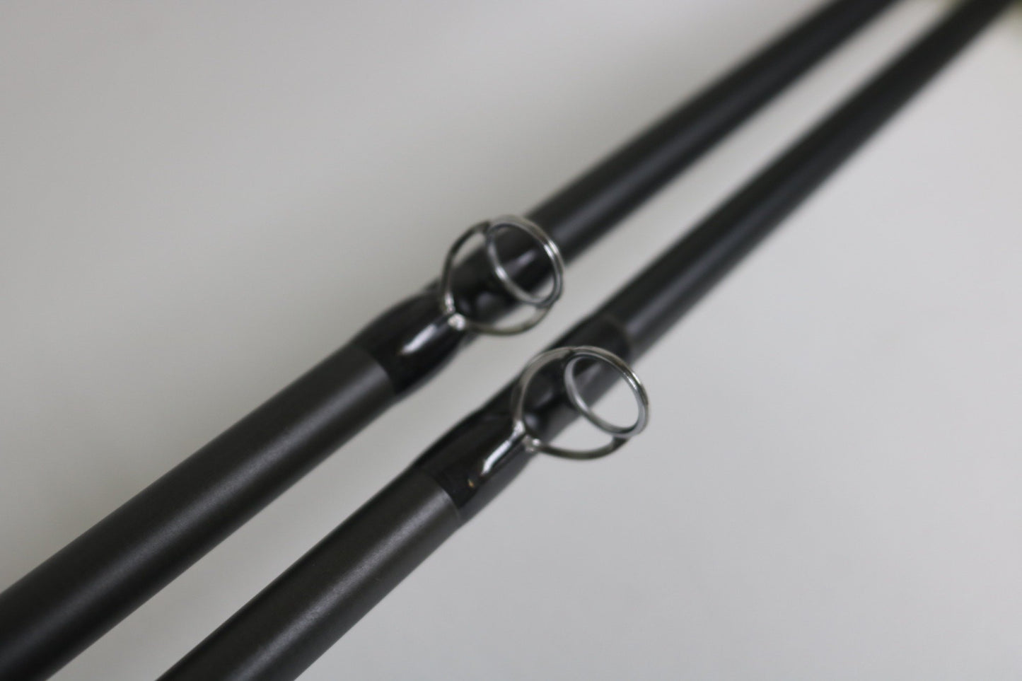 Close-up of two Temple Fork TFO Tactical Bass TAC SB 726-1 and TAC SC 746-1 casting rods (used, good condition), showing metal line guides—ideal for anglers seeking quality pre-owned gear or trade-in store credit.