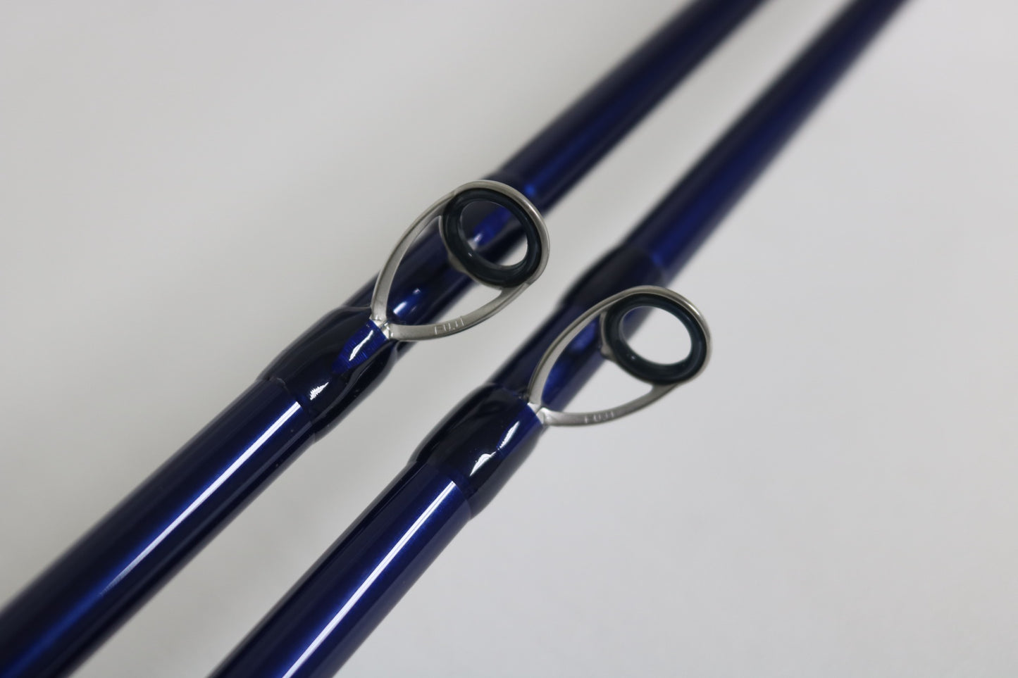 Close-up of two Douglas LRS C 704M Casting Rod tips with metal guides on a light background—ideal for anglers seeking an upgrade or using store credit on these used, very good condition rods.