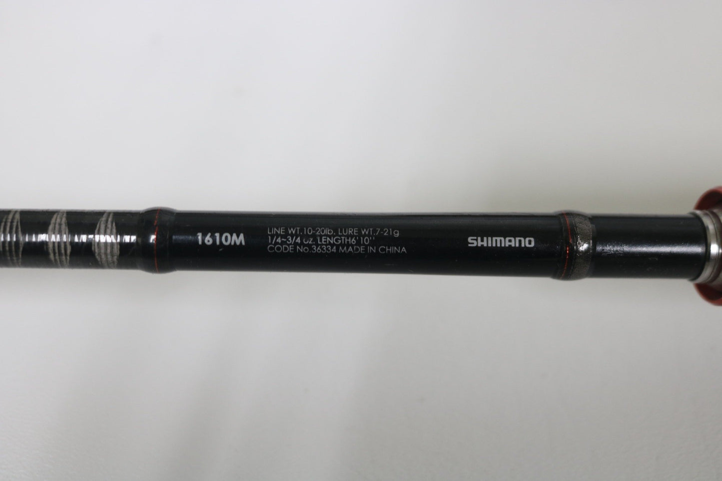 A close-up of the Shimano Zodias ZDC610MA 6'10" Medium Used Casting Rod—Very Good Condition—on a white surface, ideal for upgrading through our Rod and Reel Trade-In Program and earning store credit for your used Shimano gear.