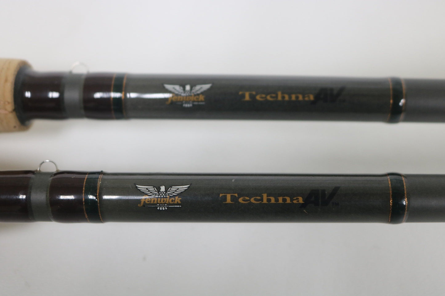 Close-up of two Fenwick Techna AV AVC79HF and AVC71HF Casting Rods in very good used condition, featuring visible branding and detailing—a great choice for those interested in quality pre-owned gear.