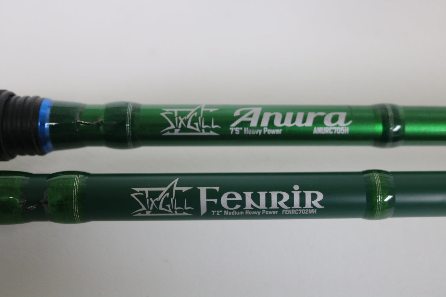 Two green SixGill casting rods, Aura ANURC705H and Fenrir FENRC702MH, Used - Very Good Condition, are shown side by side—great choices for those seeking quality pre-owned gear or planning a Rod and Reel Trade-In for store credit.