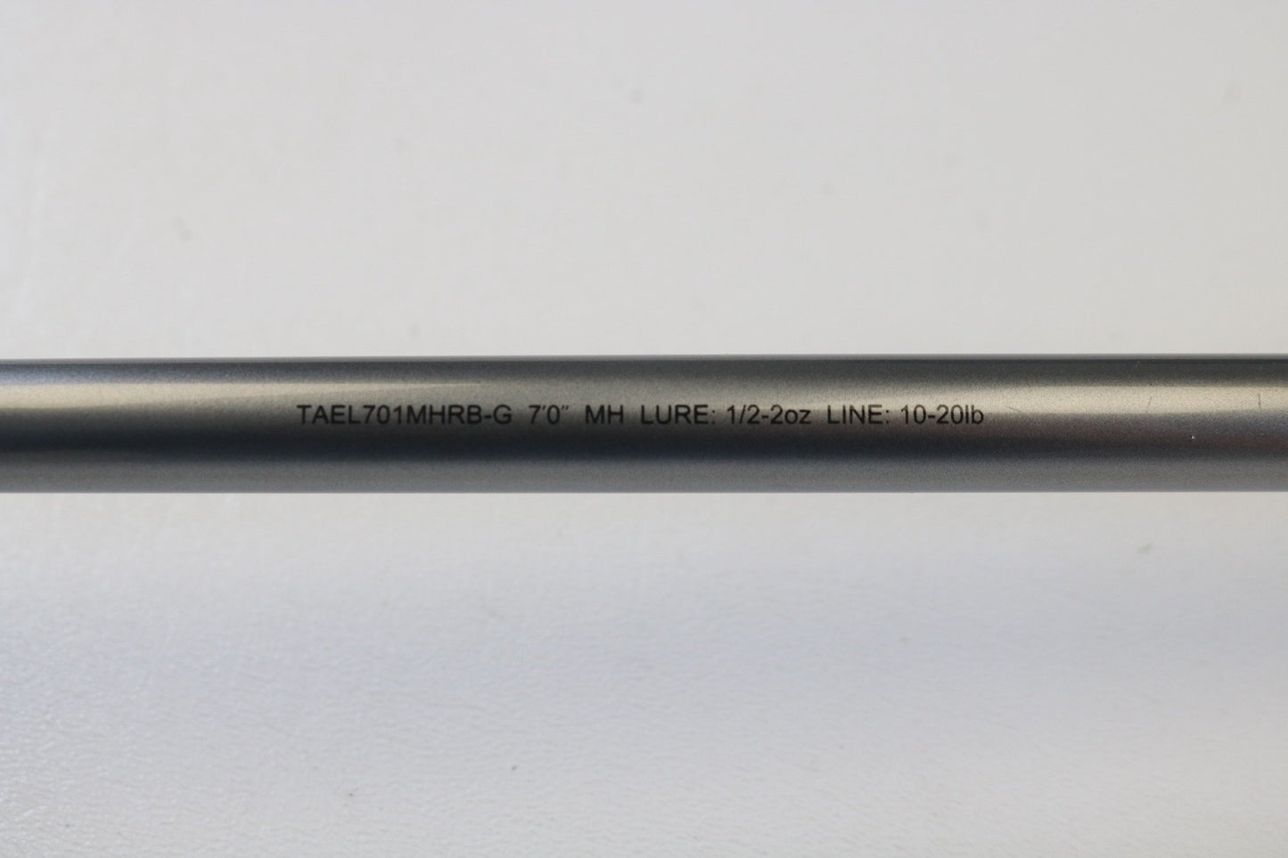 A close-up of the Daiwa Tatula Elite TAEL701MHRB-G 7'0" MH Glass Used Casting Rod, text reads "LURE: 1/2-2oz LINE: 10-20lb," perfect for those using store credit from our rod and reel trade-in program.