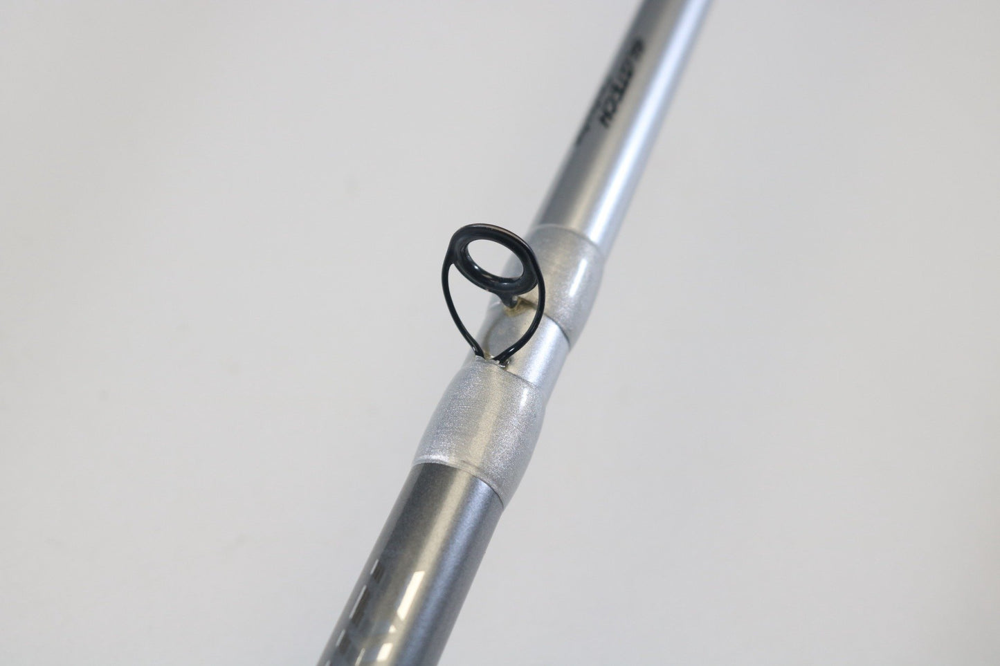 A close-up of the Daiwa Tatula Elite TAEL701MHRB-G 7'0" Medium Heavy Glass Used Casting Rod highlights a black metal line guide—perfect for showcasing quality used gear from Daiwa in our rod and reel trade-in program.