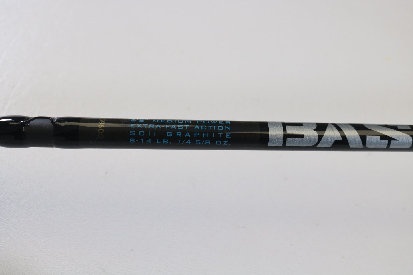 Close-up of a St. Croix Avid ASFS68MXF 6'8" Medium spinning rod, featuring SCII Graphite and extra-fast action. This black rod with blue and white lettering handles 8-14 lb line and 1/4-5/8 oz lures. Ideal for upgrading or using store credit from a trade-in.