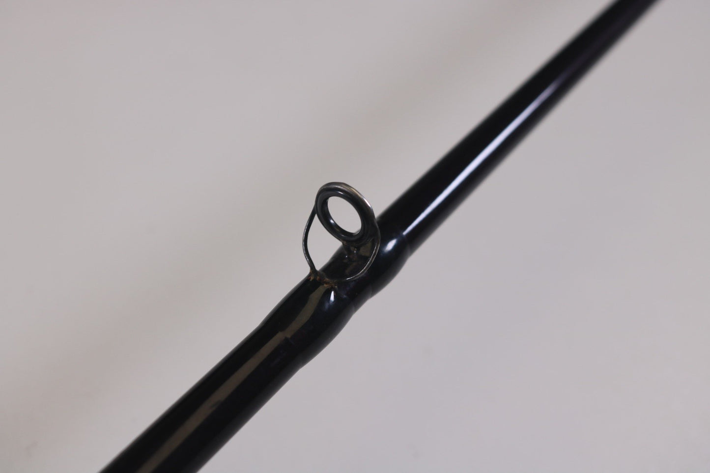 Close-up of a black St. Croix Mojo Bass MJC71MF 7'1" Medium used casting rod in very good condition, featuring a single line guide against a light background. Ideal for upgrades through the Rod and Reel Trade-In Program to earn extra store credit with your used gear.