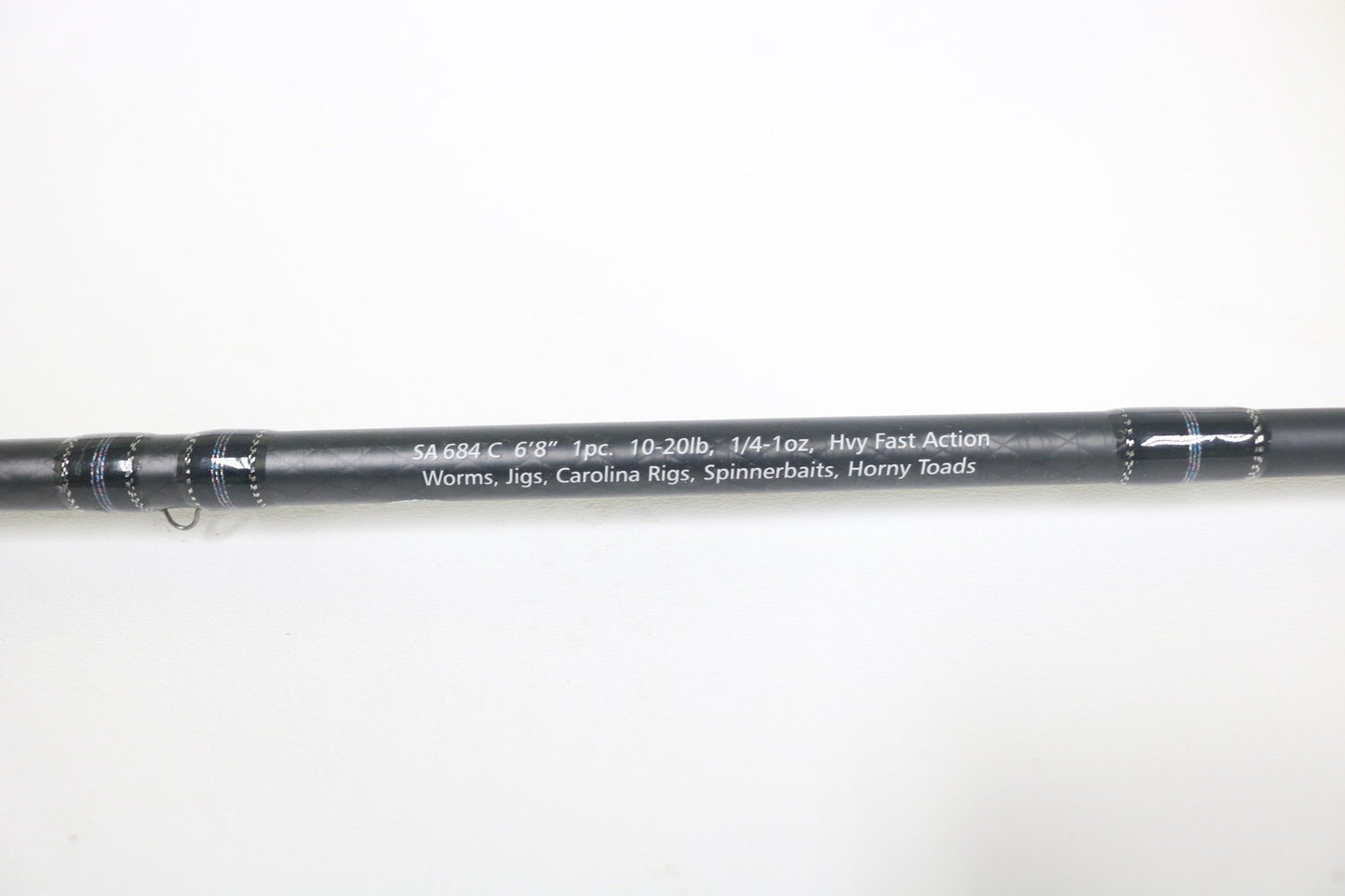 A close-up of the Dobyns Sierra SA684C Used Casting Rod in excellent condition, black with white specs: 6'8", 10-20lb, 1/4-1oz, heavy fast action—ideal for worms, jigs, Carolina rigs, spinnerbaits, and horny toads.