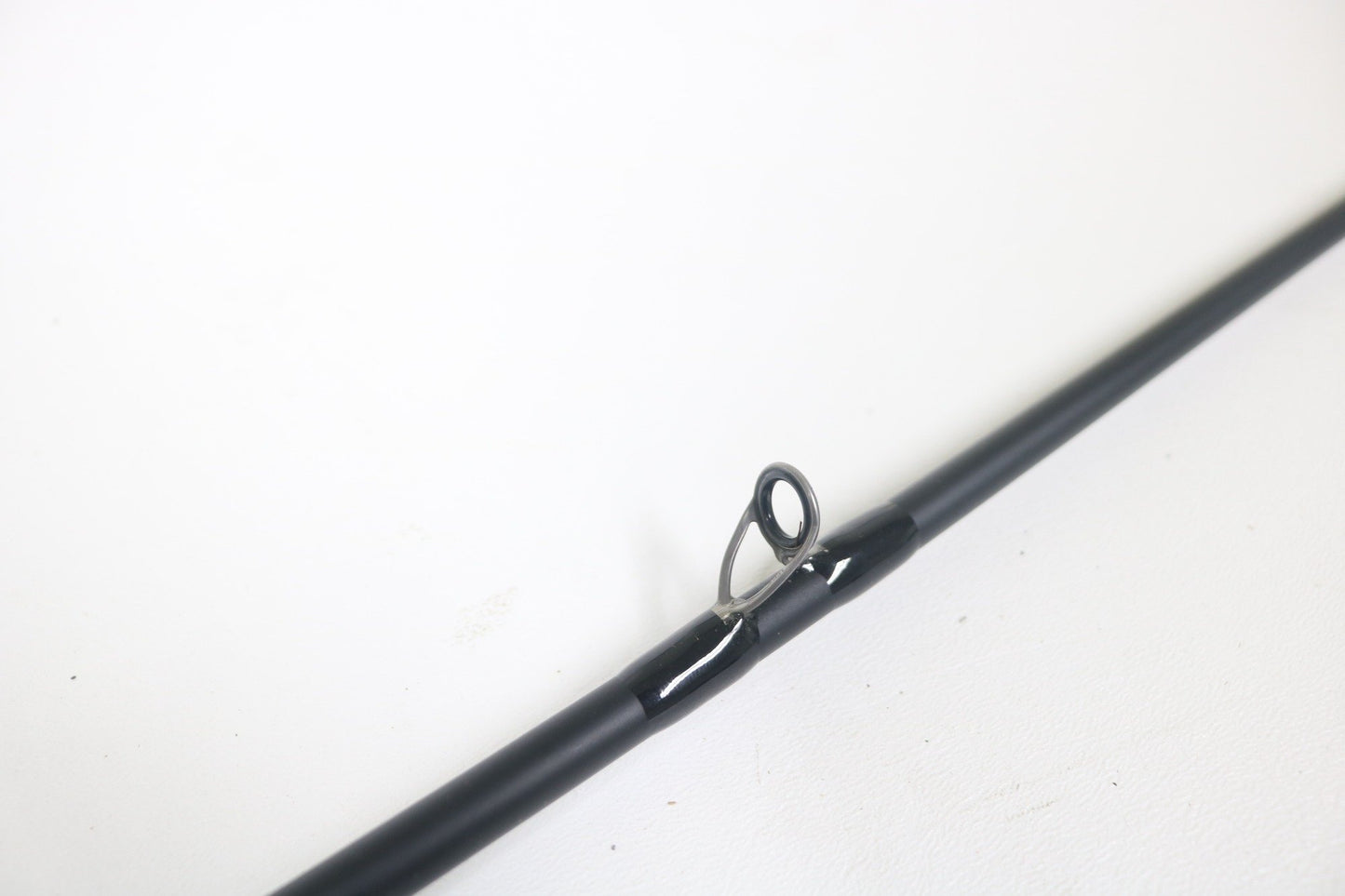 Close-up of a Dobyns Sierra SA684C Used Casting Rod in excellent condition, highlighting a single metal line guide against a plain white background.