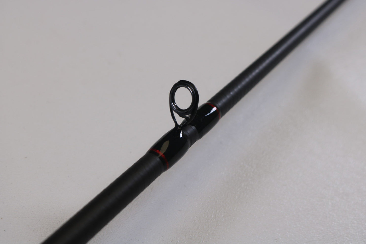 Close-up of a Dobyns Kaden KD6104CB 6'10" Medium Crankbait used casting rod in very good condition, showing the guide and stylish red accents—ideal for anglers seeking quality used gear from top brands like Dobyns.