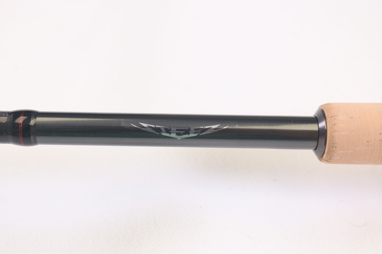 A close-up of the Daiwa Steez AGS STAGS761MMLFS 7'6" Medium Medium Light used spinning rod in mint condition, showcasing its black shaft with silver emblem and tan cork grip—perfect for anglers seeking quality pre-owned Daiwa gear.
