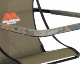 A close-up of a camouflage outdoor chair with armrests and the Millennium logo. The chair is compatible with M100U and M150 stands, and pairs perfectly with the Millennium M101 Shooting Rail for enhanced comfort.