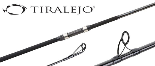 A close-up of the Shimano Tiralejo 12'0" Medium Heavy Surf Spinning Rod TRS120MHA by Shimano, showcasing Fuji Stainless Steel Guides, reel seat, Tiralejo logo, sleek black finish with metallic accents, and strong C4S Construction.