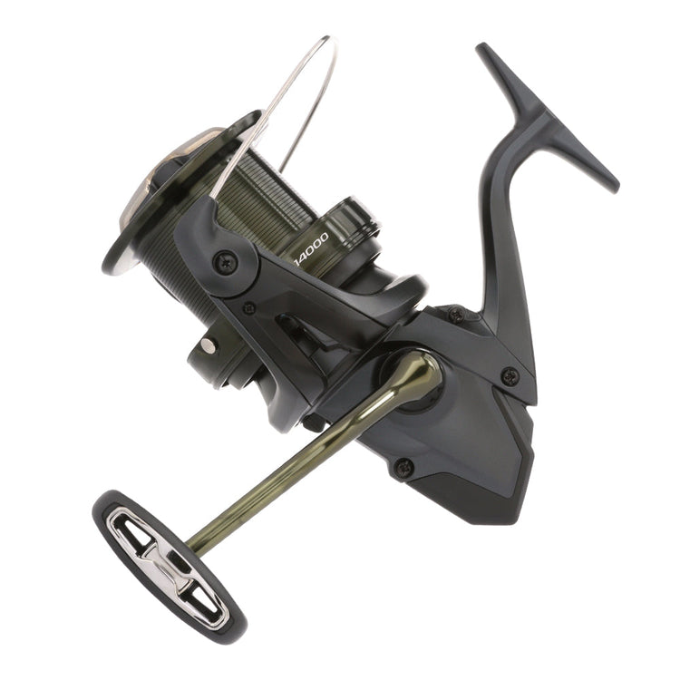 Fishing reel with a metallic silver body and black handle, featuring a wide spool for line storage. The handle is attached to the side, and the bail arm is visible in an open position.
