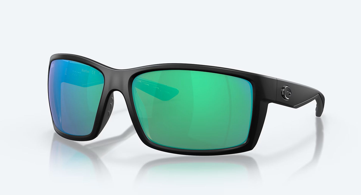 Costa Del Mar Reefton sunglasses feature a blackout frame with large, rectangular 580G green mirror glass lenses and a subtle logo on the temples, shown against a plain light gray background.