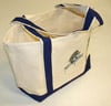 The americanlegacyfishing Fish With Attitude Deluxe Boat Tote Blue, a limited edition canvas bag with dark blue handles, trim, and a printed Fish With Attitude logo, is displayed on a light-colored surface.