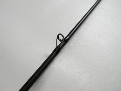 A close-up of the Dobyns Champion XP DC705CB 7'0" Medium Heavy Used Casting Rod (Excellent Condition) on a white surface, highlighting a line guide—ideal for anglers trading in gear with our Rod and Reel Trade-In Program for store credit.