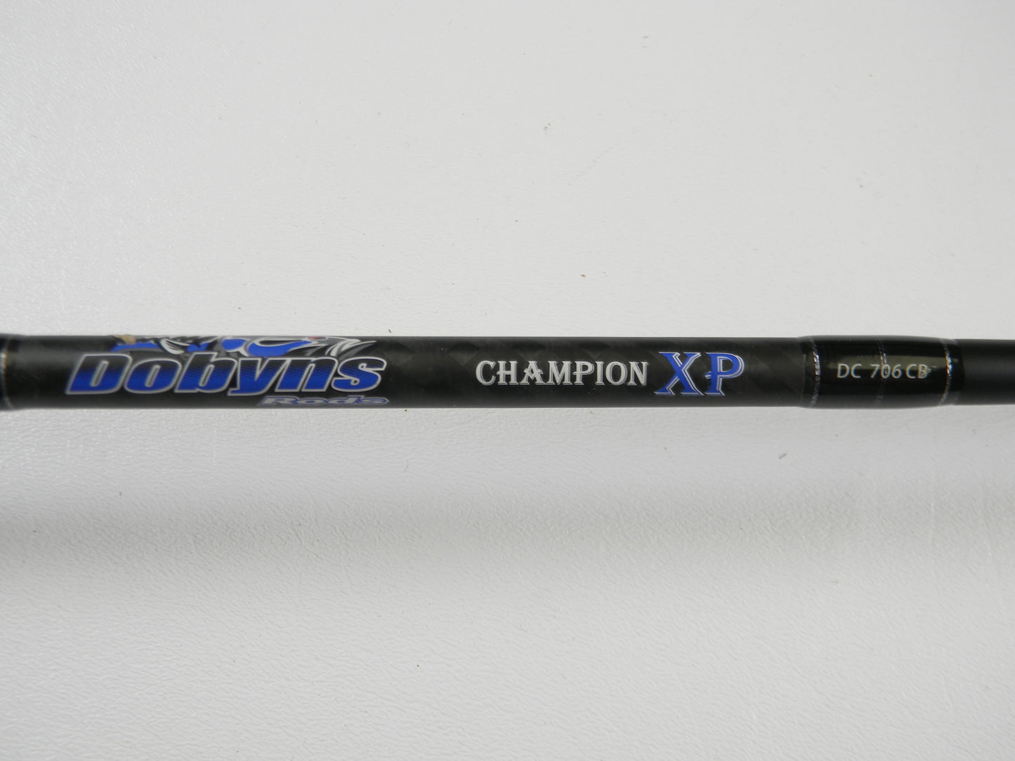 A close-up of a Dobyns Champion XP DC706CB 7'0" Heavy Used Casting Rod in excellent condition against a white background—ideal for Rod and Reel Trade-In or adding top-quality used Dobyns gear to your collection.