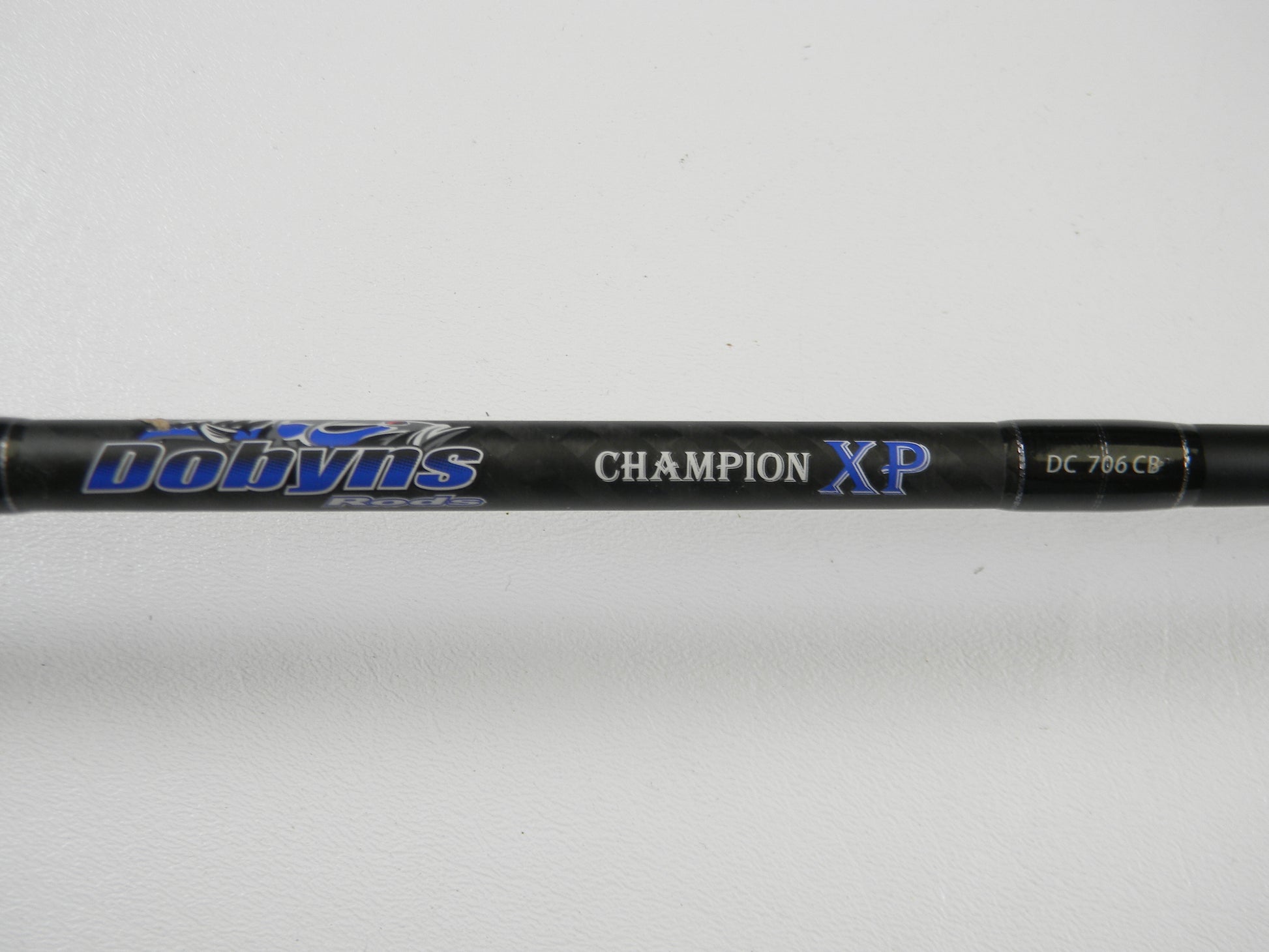 A close-up of a Dobyns Champion XP DC706CB 7'0" Heavy Used Casting Rod in excellent condition against a white background—ideal for Rod and Reel Trade-In or adding top-quality used Dobyns gear to your collection.