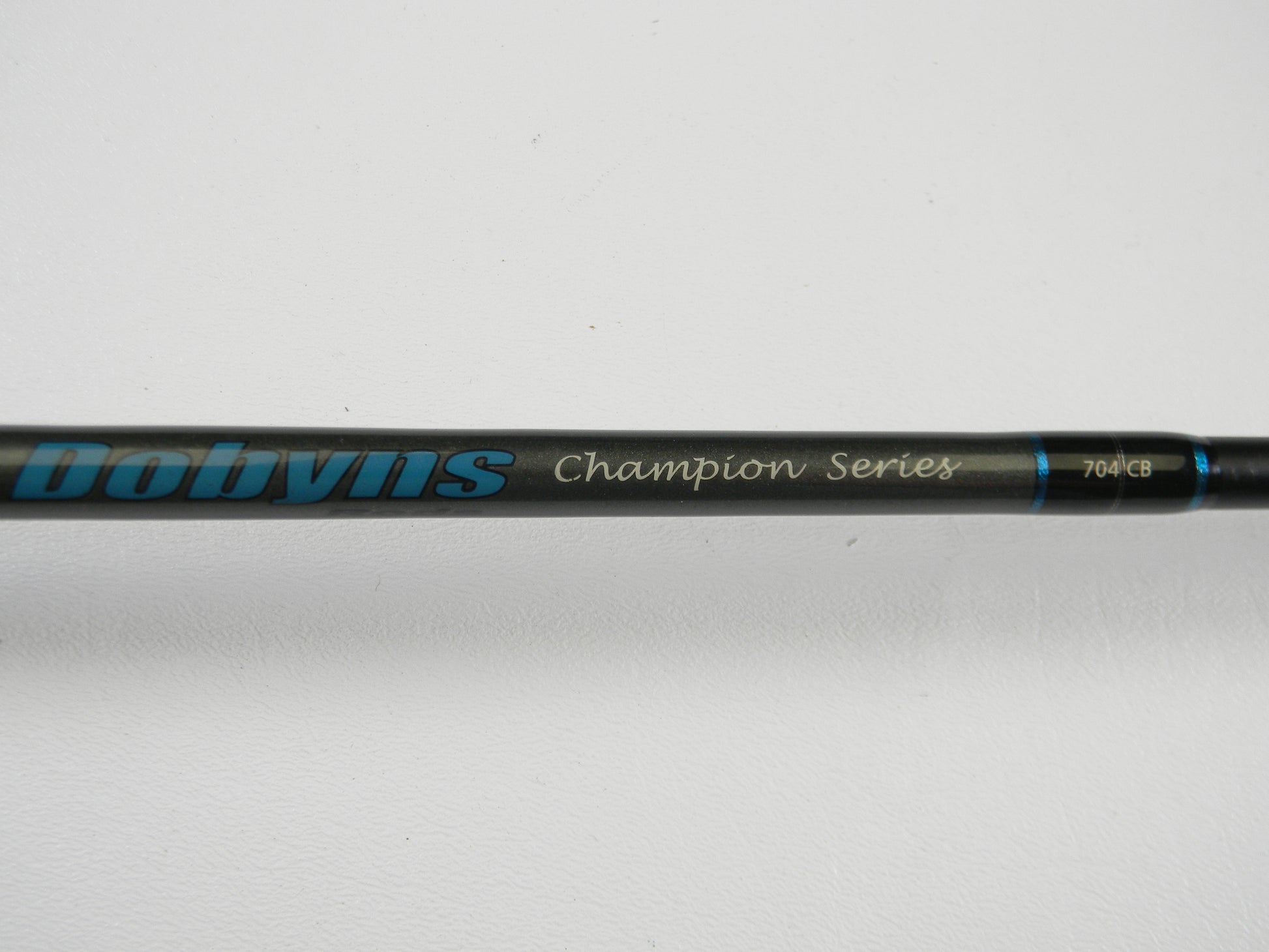 Close-up of a Dobyns Champion Gen 2 DC 704 CB 7'0" Medium casting rod, used in excellent condition—perfect for our Rod and Reel Trade-In Program. Trade your pre-owned gear for store credit today!.