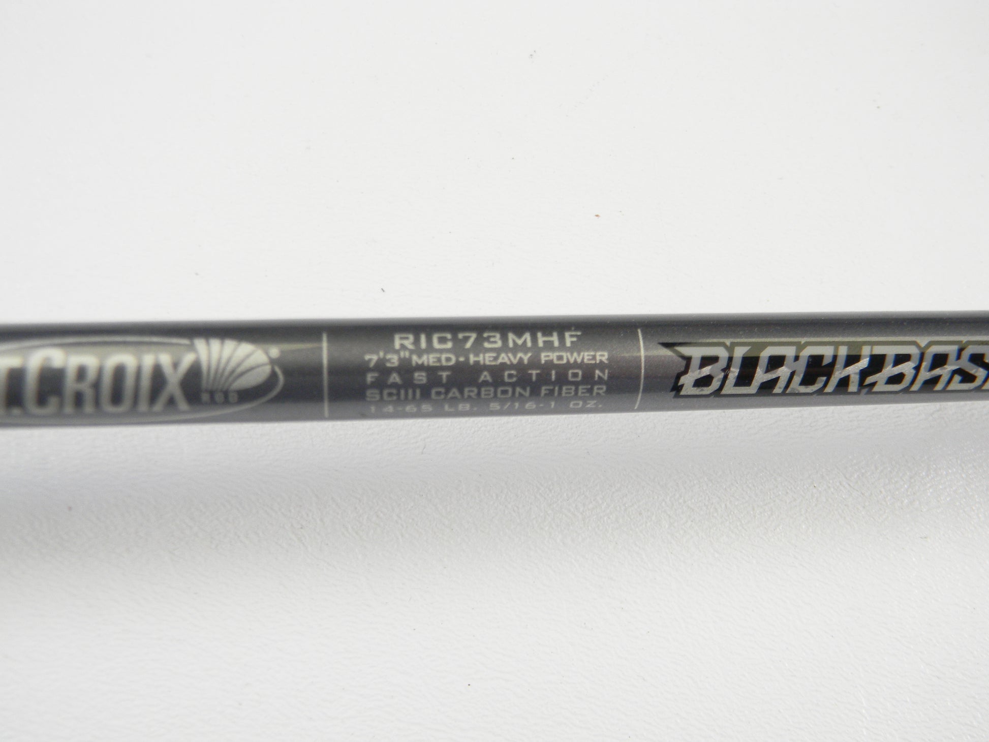 A close-up of the St. Croix Black Bass RIC73MHF 7'3" Medium Heavy Casting Rod in excellent used condition displays its label—ideal for store credit with our Rod and Reel Trade-In Program.