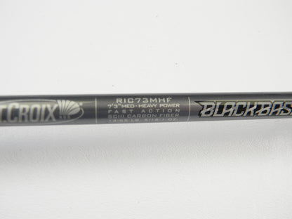 A close-up of the St. Croix Black Bass RIC73MHF 7'3" Medium Heavy Casting Rod in excellent used condition displays its label—ideal for store credit with our Rod and Reel Trade-In Program.