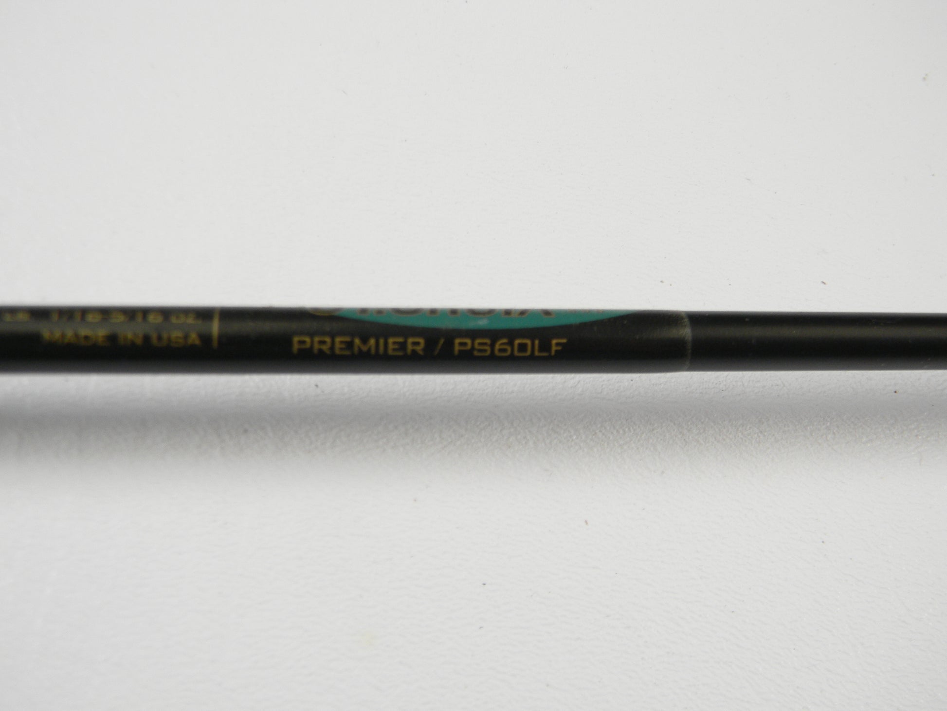 Close-up of a St. Croix Premier PS60LF 6'0" Light Used Spinning Rod in good condition, with gold branding on a black shaft, shown on a white background. Partially visible, this gear is part of our Rod and Reel Trade-In Program.