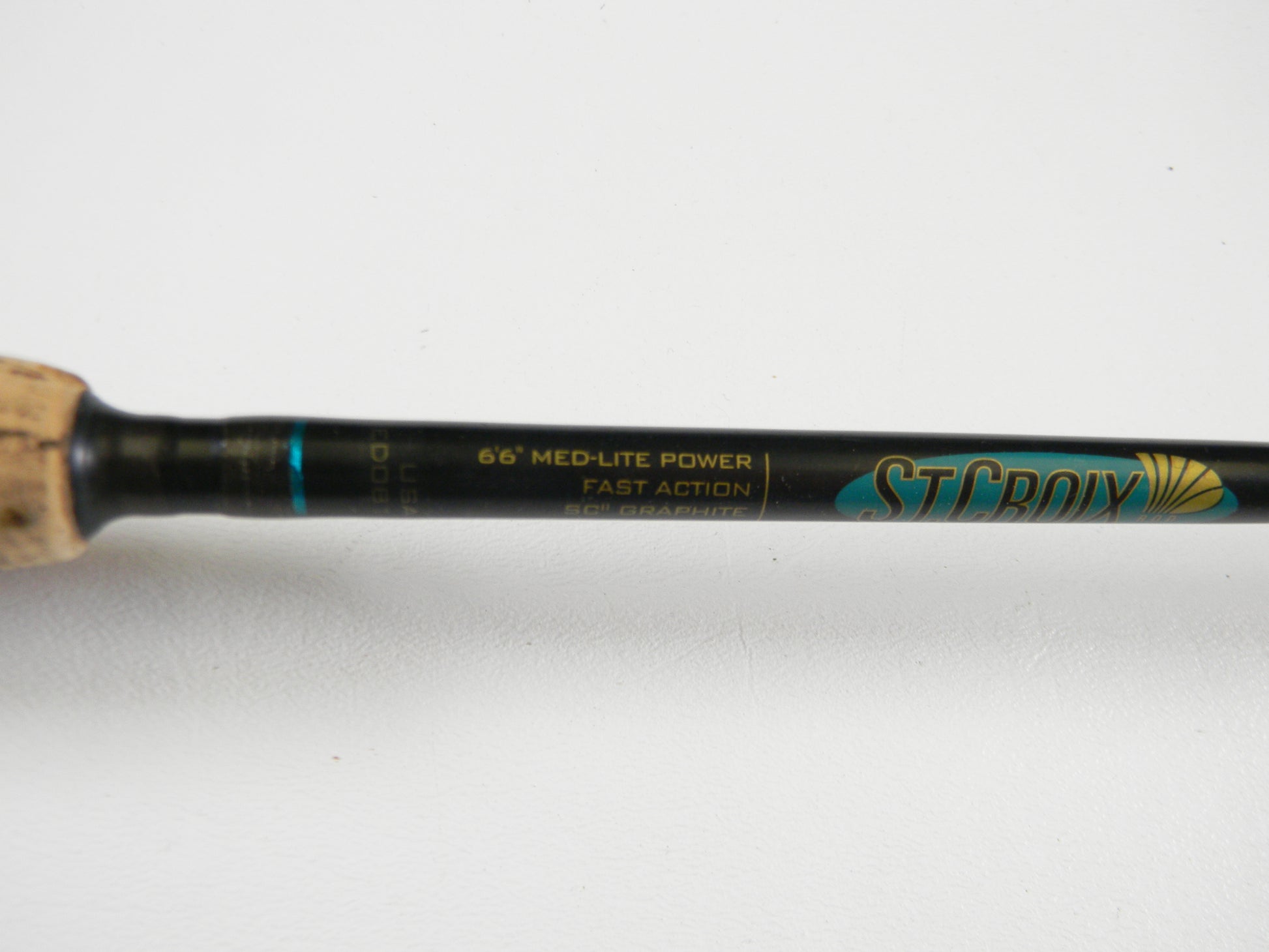 Close-up of the St. Croix Premier PS66MLF 6'6" Medium Light spinning rod (used, good condition) showing handle and label details. "St. Croix" branding in blue and gold is visible. Upgrade your gear with our Rod and Reel Trade-In Program for store credit.