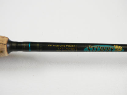 Close-up of the St. Croix Premier PS66MLF 6'6" Medium Light spinning rod (used, good condition) showing handle and label details. "St. Croix" branding in blue and gold is visible. Upgrade your gear with our Rod and Reel Trade-In Program for store credit.