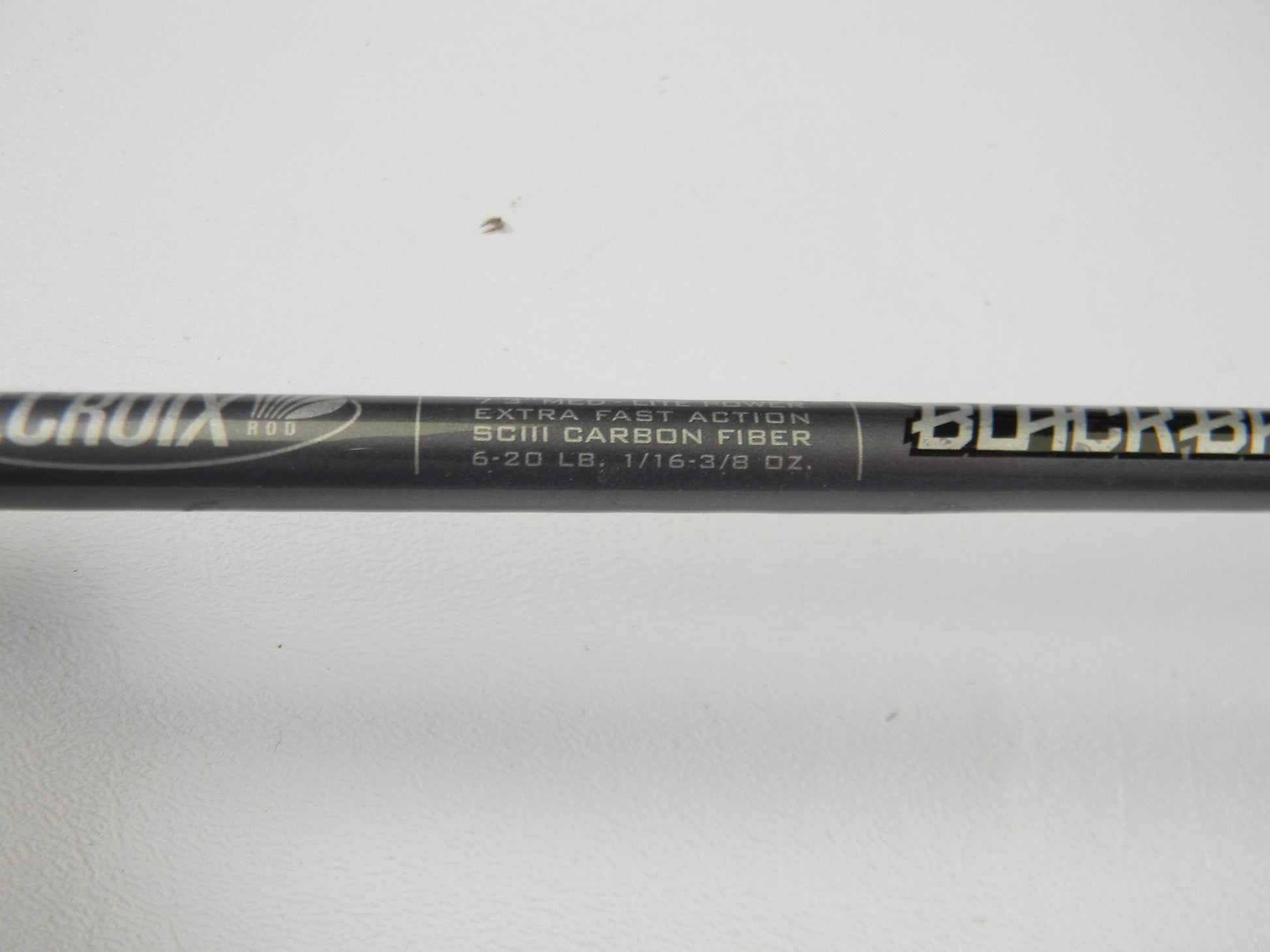 Close-up of the St. Croix Black Bass RIS73MLXF 7'3" Medium Light Used Spinning Rod in excellent condition, featuring "Extra Fast Action SCIII Carbon Fiber 6-20 lb, 1/16 - 3/8 oz." Eligible for our Rod and Reel Trade-In Program. Plain white background.