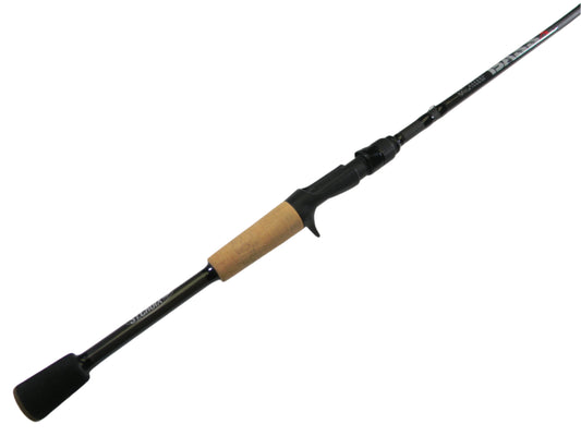 Displayed diagonally against a white background, the St. Croix Bass X BACX66MF 6'6" Medium - Used Casting Rod features a black and tan design with a cork handle, black reel seat with trigger grip, and tapered tip. It's in excellent condition and eligible for our Rod and Reel Trade-In Program.