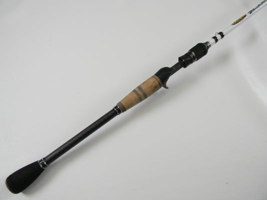 The Duckett Black Ice DFBI80MH-CC 8'0" Medium Heavy Crankin' casting rod, with a cork handle and black grip, lies on a white surface. Its black finish with metallic accents and marked white top make it ideal for enthusiasts in our Rod and Reel Trade-In Program.
