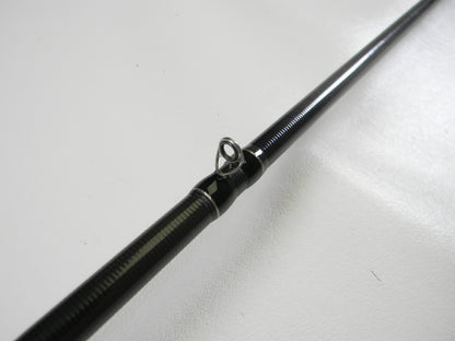 Close-up of a Duckett Black Ice DFBI80MH-CC 8'0" Medium Heavy Crankin' Casting Rod in excellent condition, features a black finish with line guide, set against a plain white background. Consider our Rod and Reel Trade-In Program for valuable store credit on used gear.
