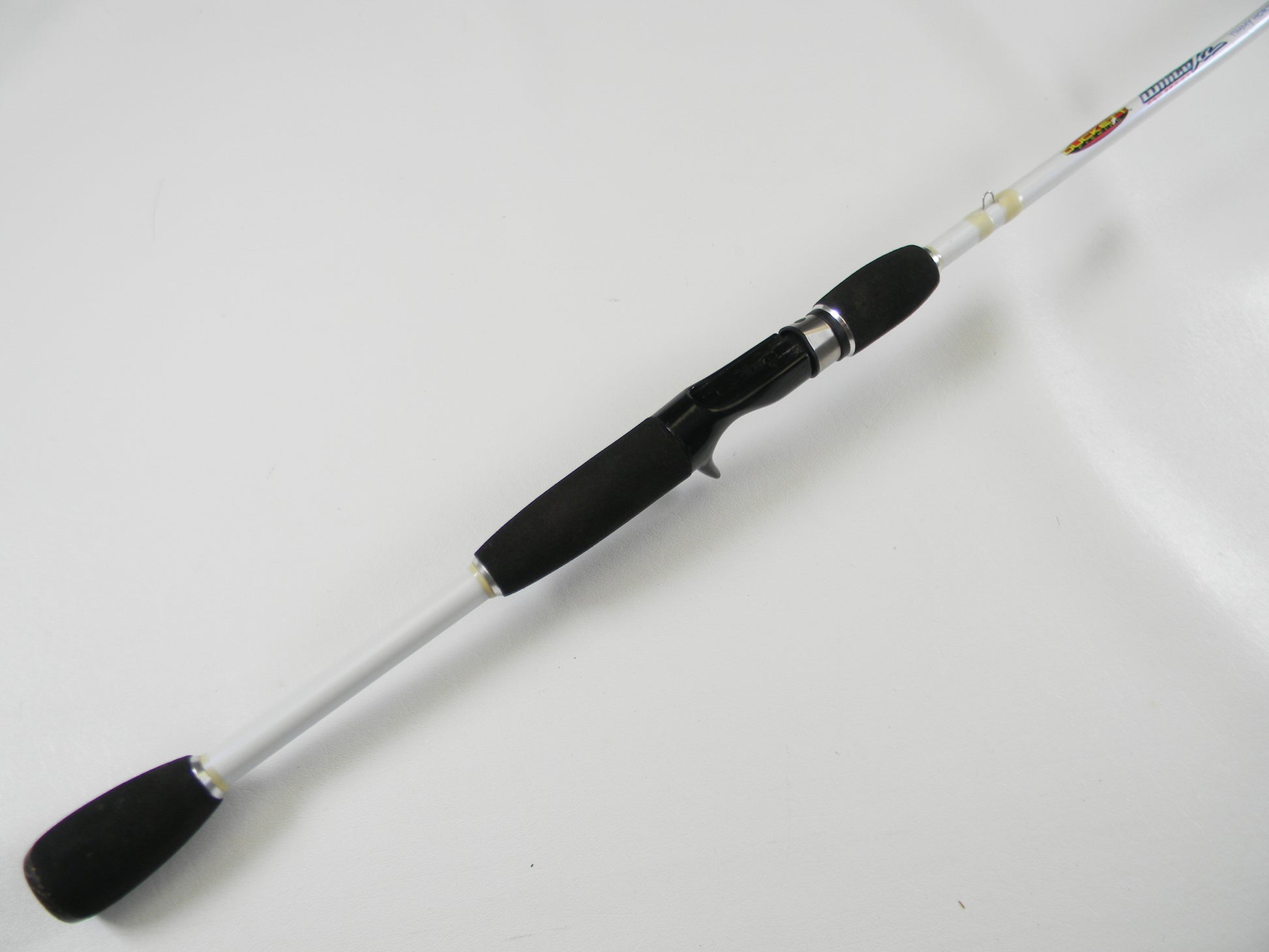 The Duckett White Ice DFWI70MCC Timmy Horton 7'0" Medium Crankin' is a white casting rod with black grips and reel seat, ideal for upgrades through our Rod and Reel Trade-In Program.