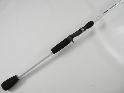 Laid diagonally on a white background, the Duckett White Ice DFWI711HC Byron Velvick 7'11" Heavy A-Rig/Swimbait used casting rod features a black handle and silver shaft. Enjoy its secure grip and metallic accents for your next catch. Trade it in through our Rod and Reel Trade-In Program for store credit.