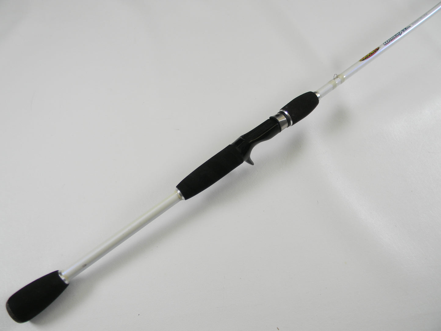 The Duckett White Ice DFWI711MHCC Byron Velvick 7'11" Medium Heavy Lure Launcher, a used casting rod in very good condition with a white shaft and black handle, is perfect for quality gear seekers. Consider our rod and reel trade-in options to upgrade or earn store credit.