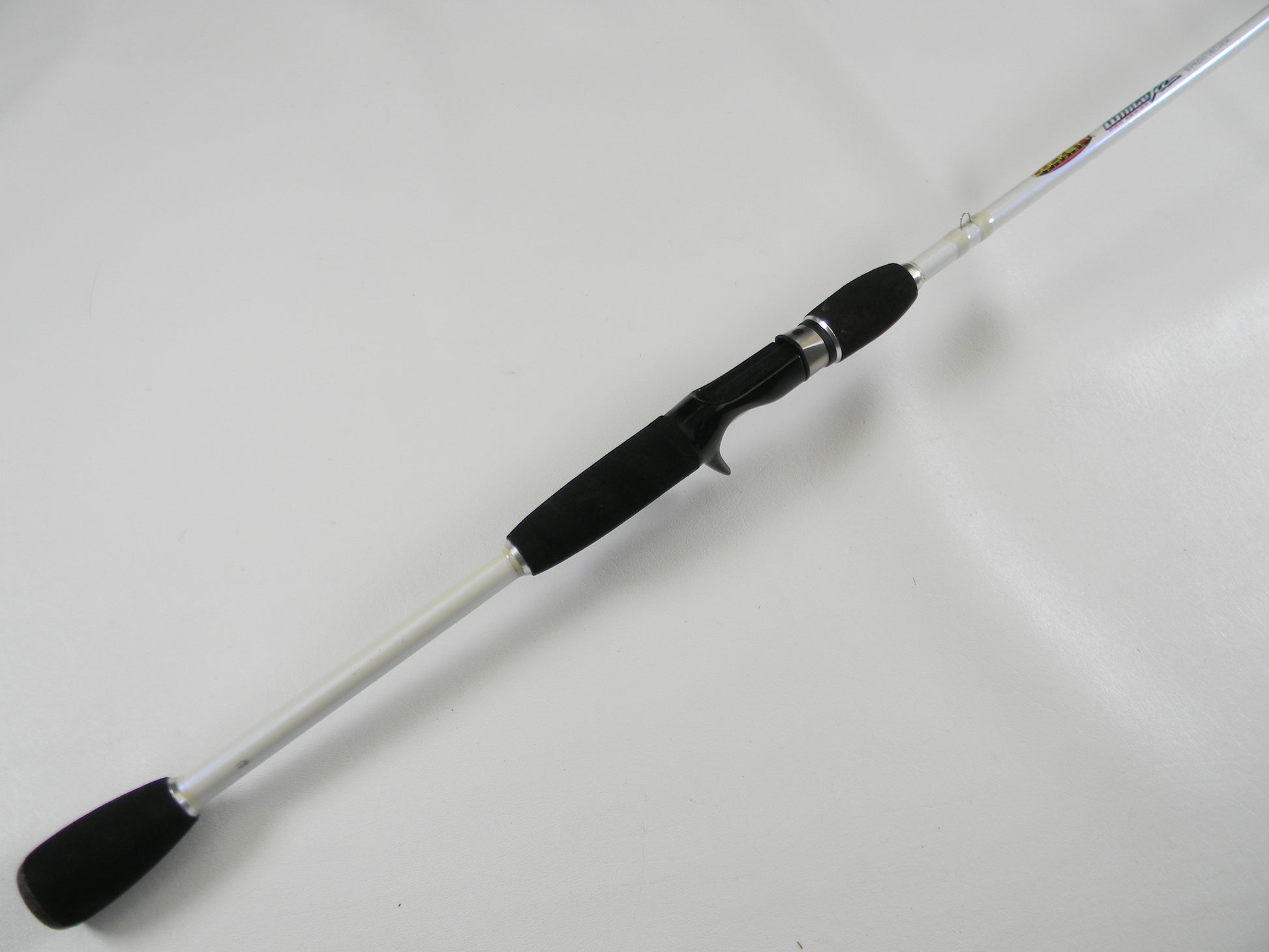 The Duckett White Ice DFWI711MHCC Byron Velvick 7'11" Medium Heavy Lure Launcher, a used casting rod in very good condition with a white shaft and black handle, is perfect for quality gear seekers. Consider our rod and reel trade-in options to upgrade or earn store credit.