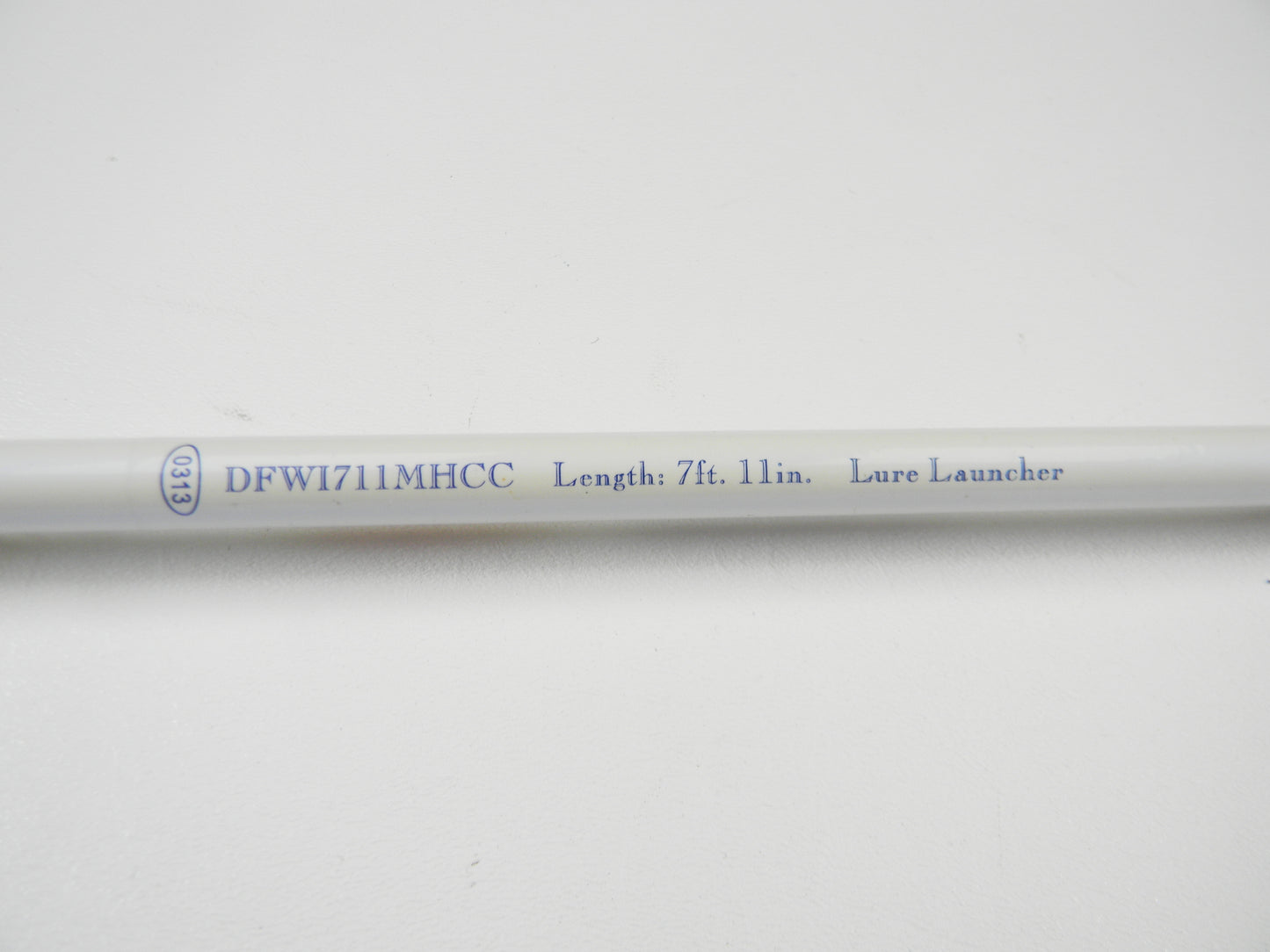 Close-up of a Duckett White Ice DFWI711MHCC Byron Velvick 7'11" Medium Heavy Lure Launcher, showing "DFW1711MHCC Length: 7 ft. 11 in." The used casting rod is in very good condition and features black text on a white background, ideal for Rod and Reel Trade-In opportunities.