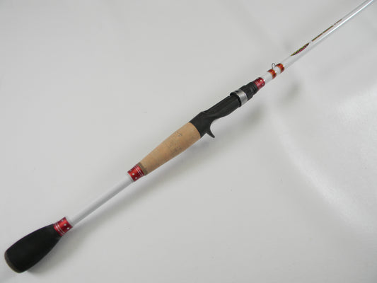 The Duckett Micro Magic Pro DFMP69MHC, a 6'9" medium-heavy casting rod with a light-colored body, cork handle, and black and red accents, rests on a white surface. Ideal for upgrading through the Rod and Reel Trade-In Program, it elegantly tapers from handle to tip.