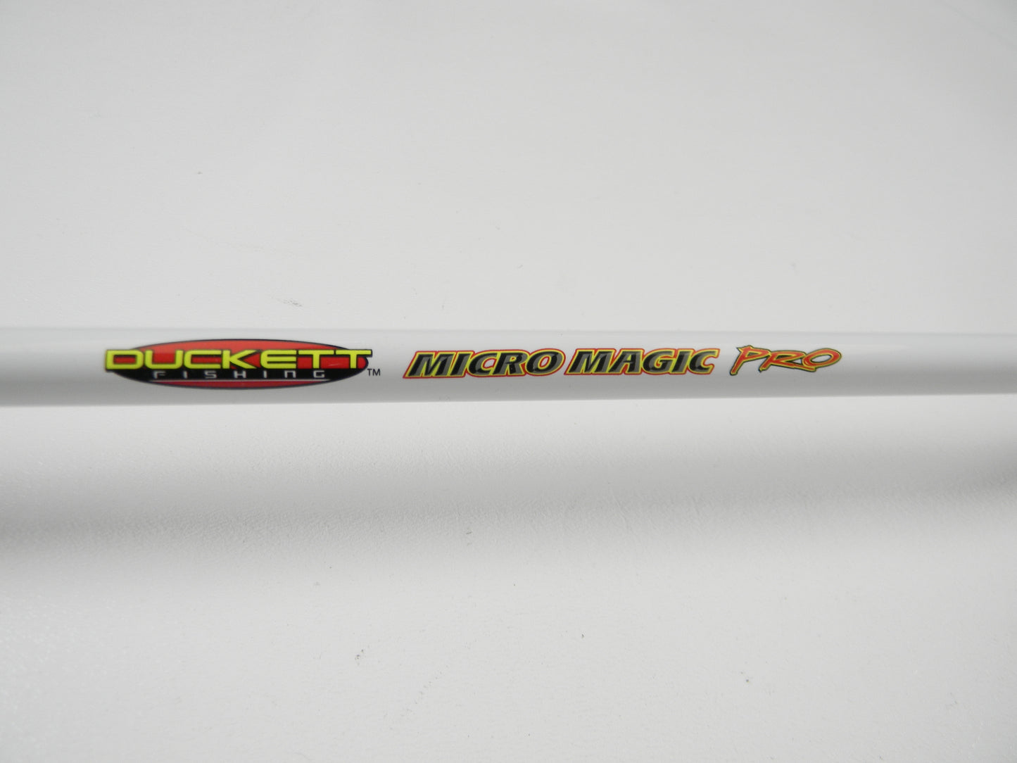 Close-up of a used Duckett Micro Magic Pro DFMP69MHC 6'9" Medium Heavy casting rod in excellent condition, branded with the "Duckett" logo. Eligible for our Rod and Reel Trade-In Program for store credit towards new or used gear. Set against a plain white background.