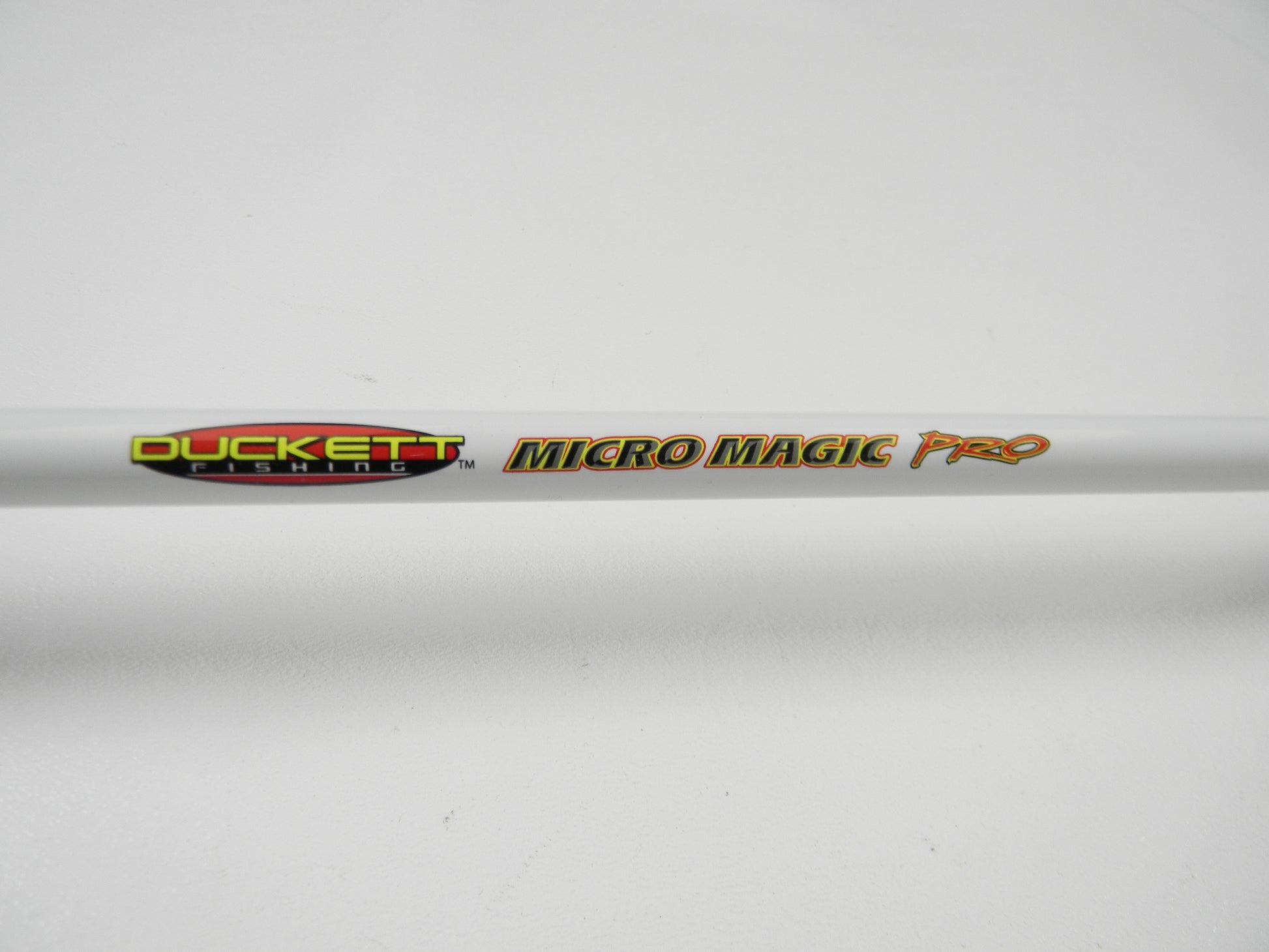 Close-up of a used Duckett Micro Magic Pro DFMP69MHC 6'9" Medium Heavy casting rod in excellent condition, branded with the "Duckett" logo. Eligible for our Rod and Reel Trade-In Program for store credit towards new or used gear. Set against a plain white background.