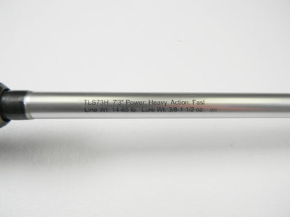 A close-up of Lew's Signature Series TLS73H Frog 7'3" Heavy, featuring specs: Power: Heavy, Action: Fast, Line Weight: 14-65 lb., Lure Weight: 3/8-1 1/2 oz. Against a white background, it's an ideal choice for exploring used gear conditions during rod and reel trade-in events.