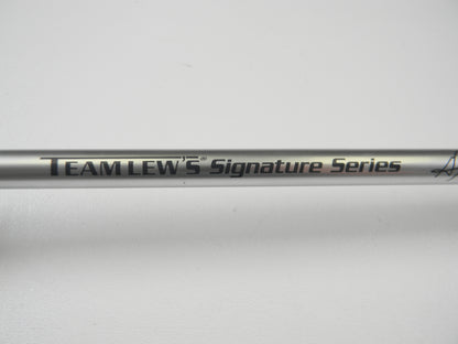 Close-up of a Lew's Signature Series TLS73H Frog 7'3" Heavy Casting Rod in excellent condition, featuring black "Team Lew's Signature Series" text on a metallic finish. Ideal for Rod and Reel Trade-In, the plain white background highlights its sleek design and pristine performance.