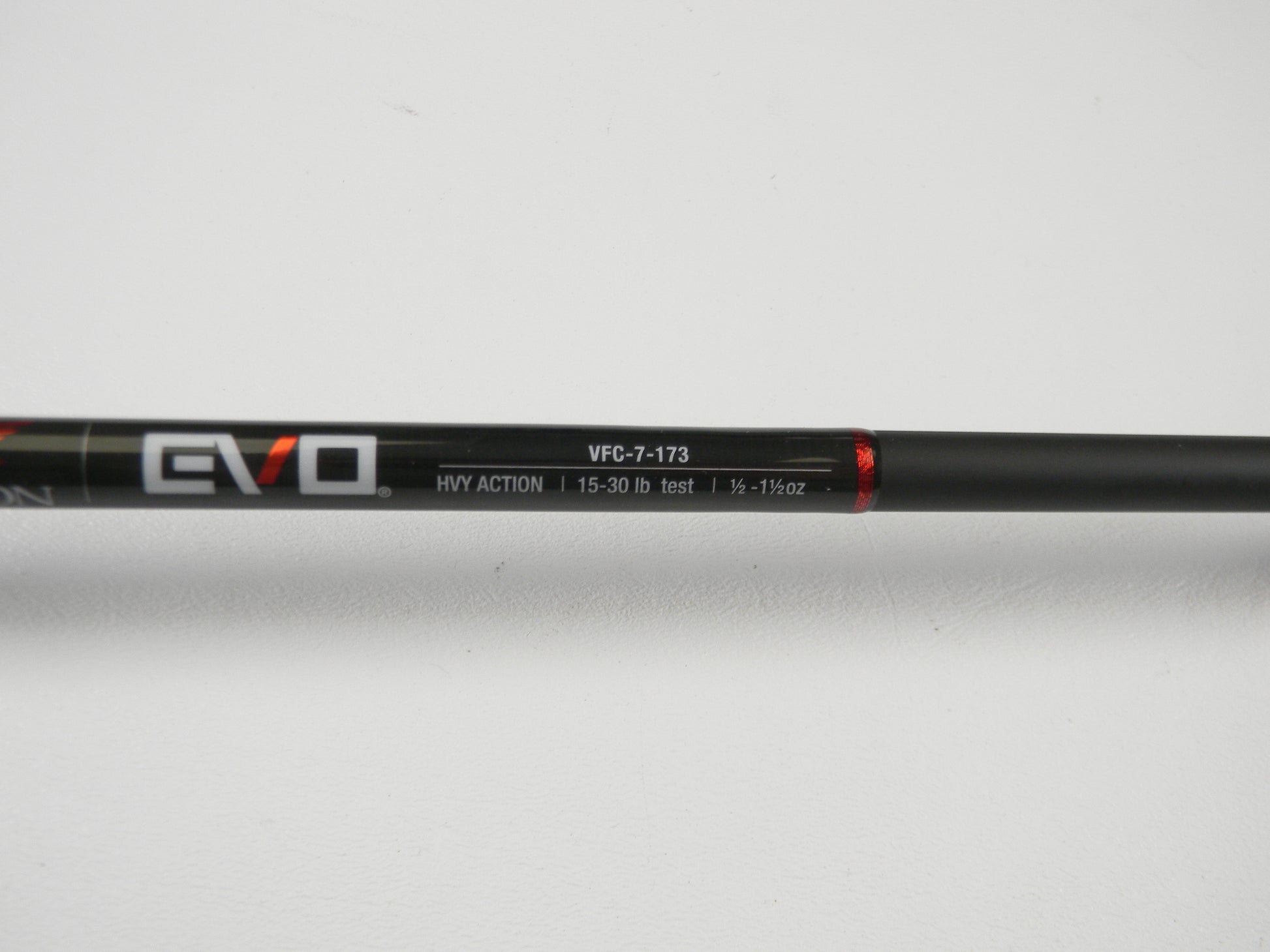 Close-up of a black Falcon EVO casting rod with "VFC-7-173," "HVY ACTION," and line weight specs "15-30 lb test, 1/2 - 1 1/2 oz" text in white and red. Perfect for our Rod and Reel Trade-In Program, even if used. Photographed against a white background.